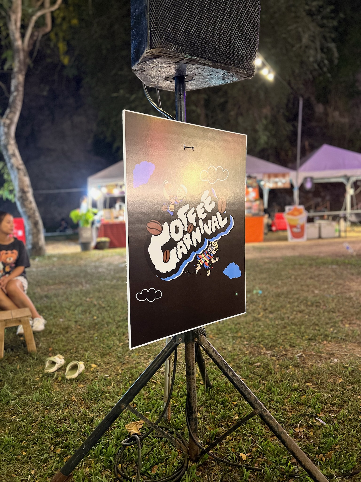 Coffee Carnival sign at a lively outdoor night event