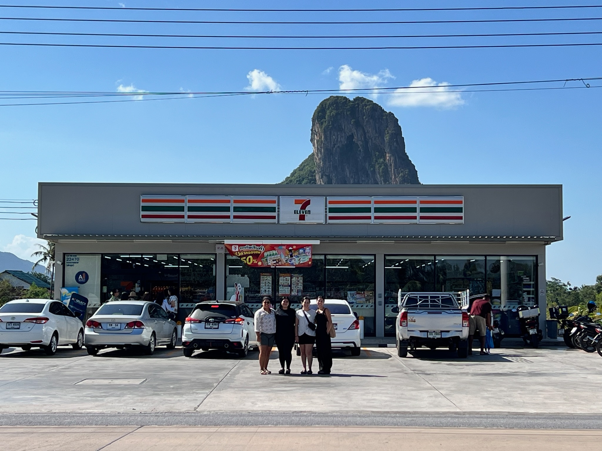 Friends stopping beneath a striking limestone mountain