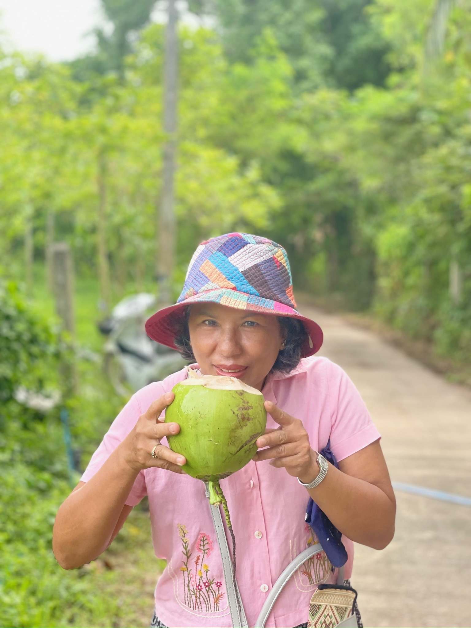 A friend enjoying fresh coconut water on a country road
