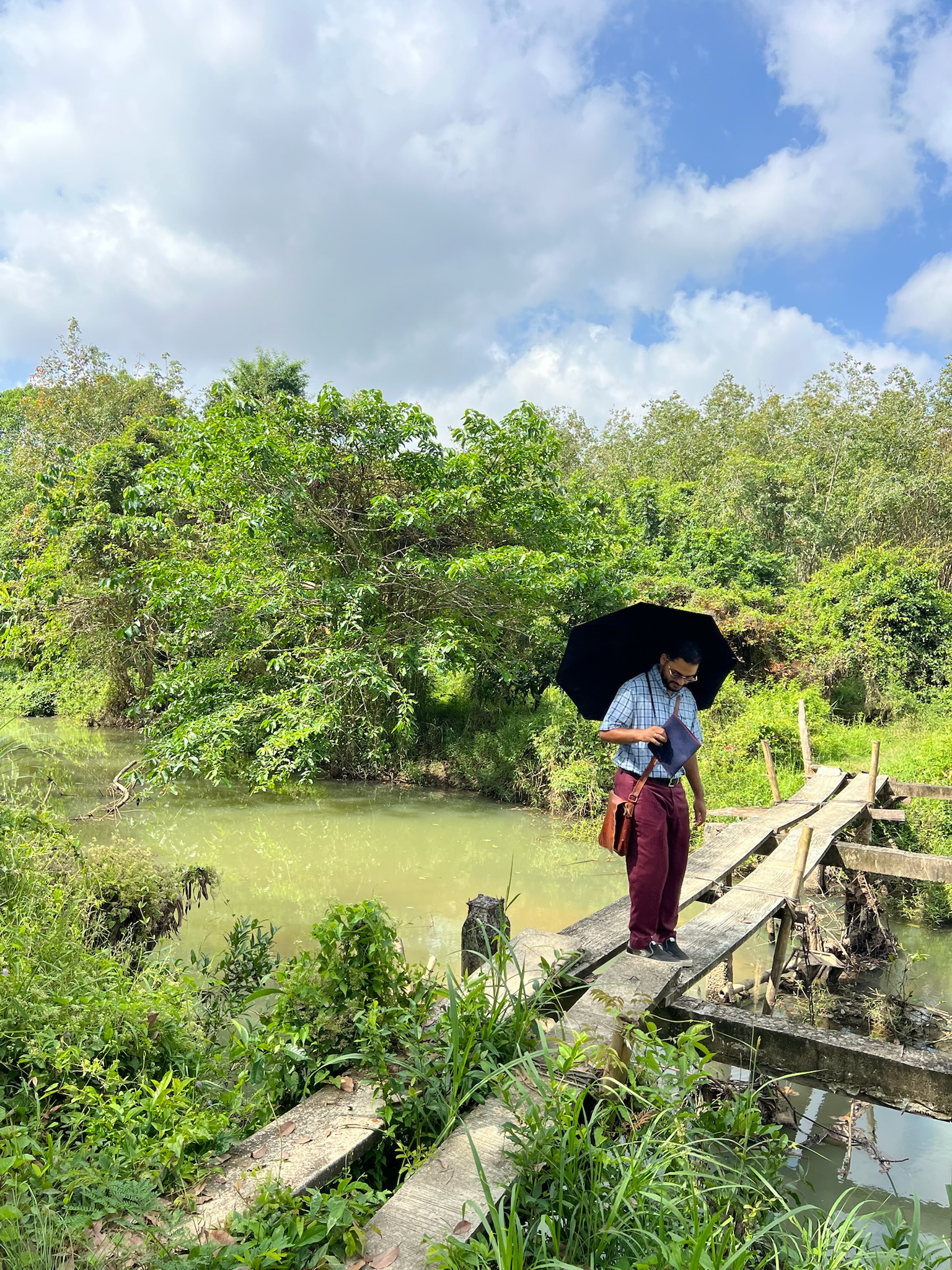 A friend crossing a small countryside bridge