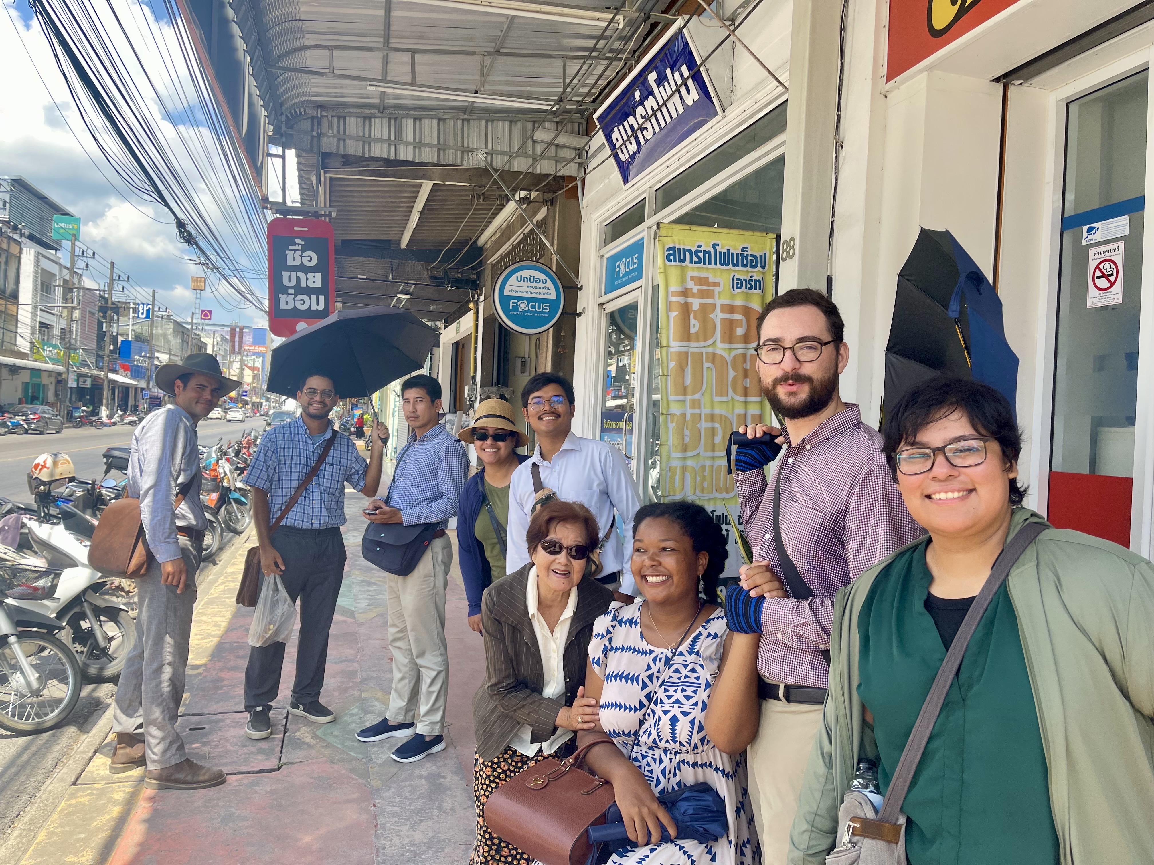 A joyful congregation group together on a Phatthalung street