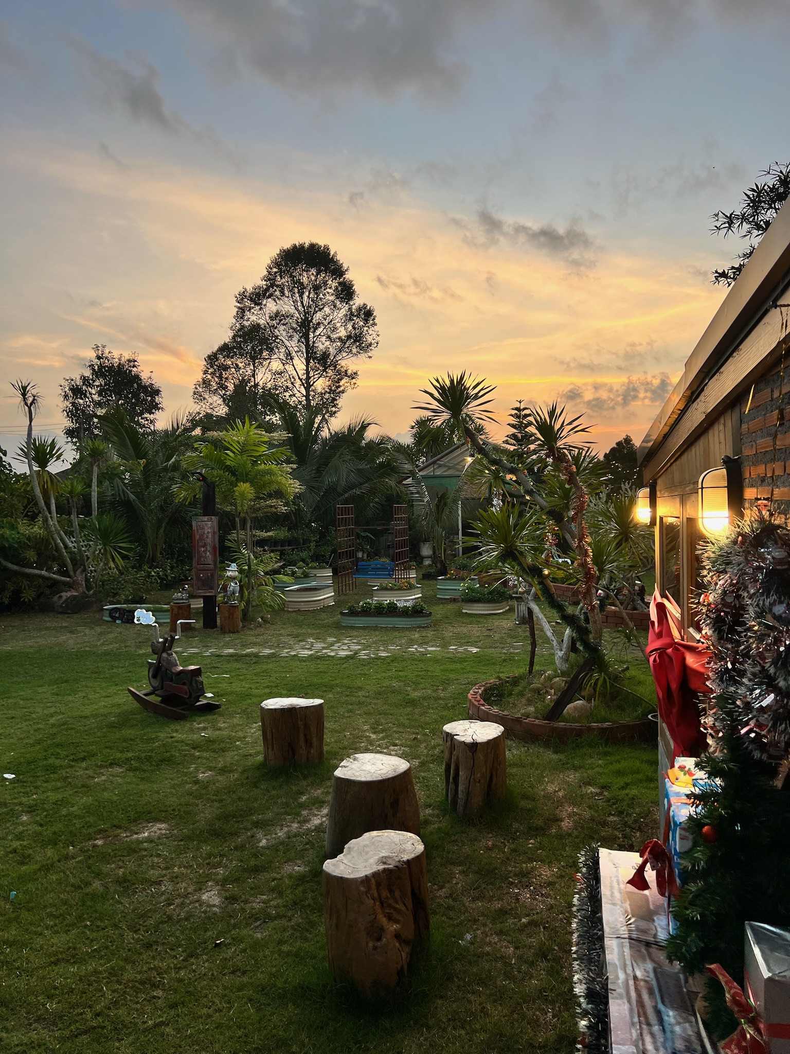 A peaceful garden glowing beneath a warm Phatthalung sunset