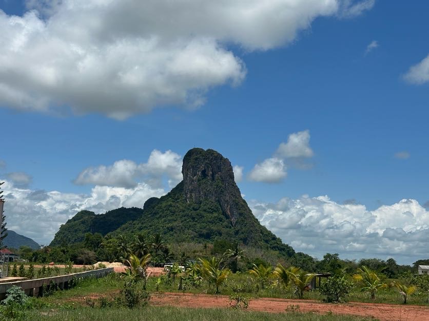 A distinctive limestone mountain beneath bright Phatthalung skies