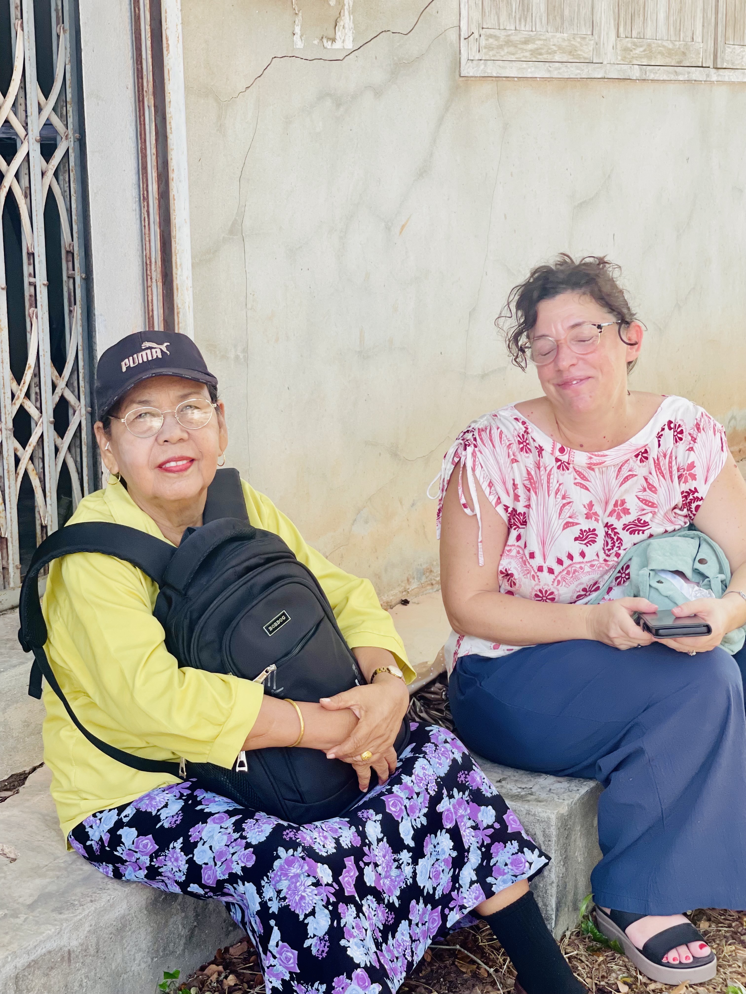 Two friends resting and laughing together after a warm day