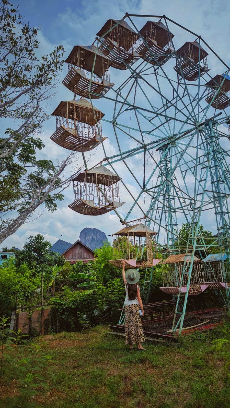 A vintage village Ferris wheel with Phatthalung mountains beyond